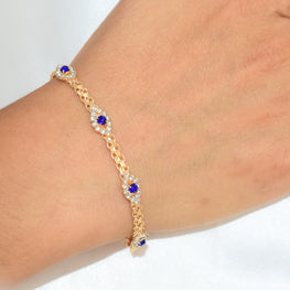 Gold plated bracelet with multiple sapphire blue evil eye charms